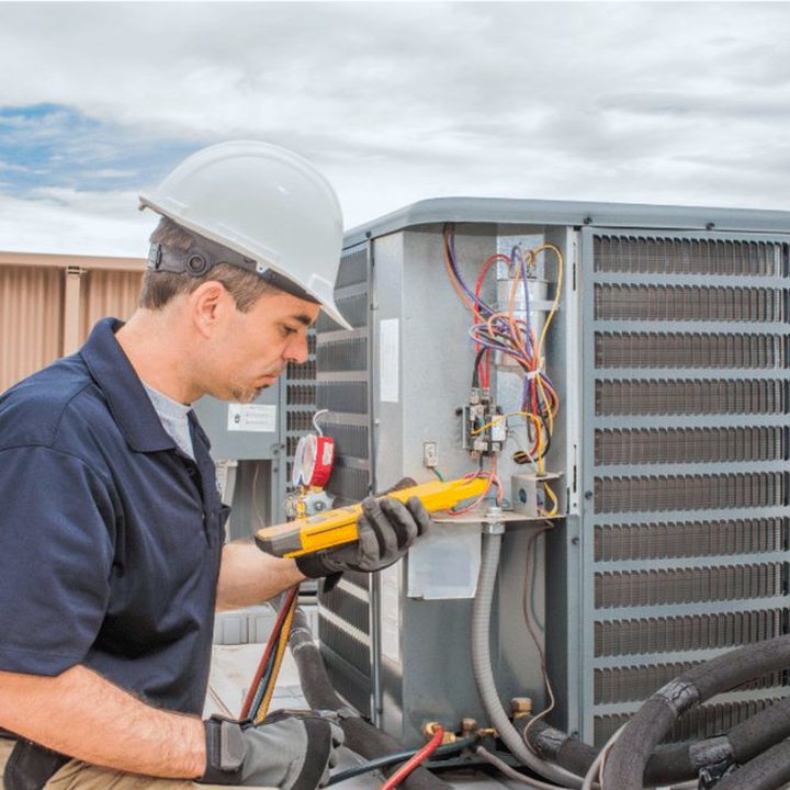 Ridgetown Heating & Cooling technician servicing a propane furnace on a Chatham-Kent farm call